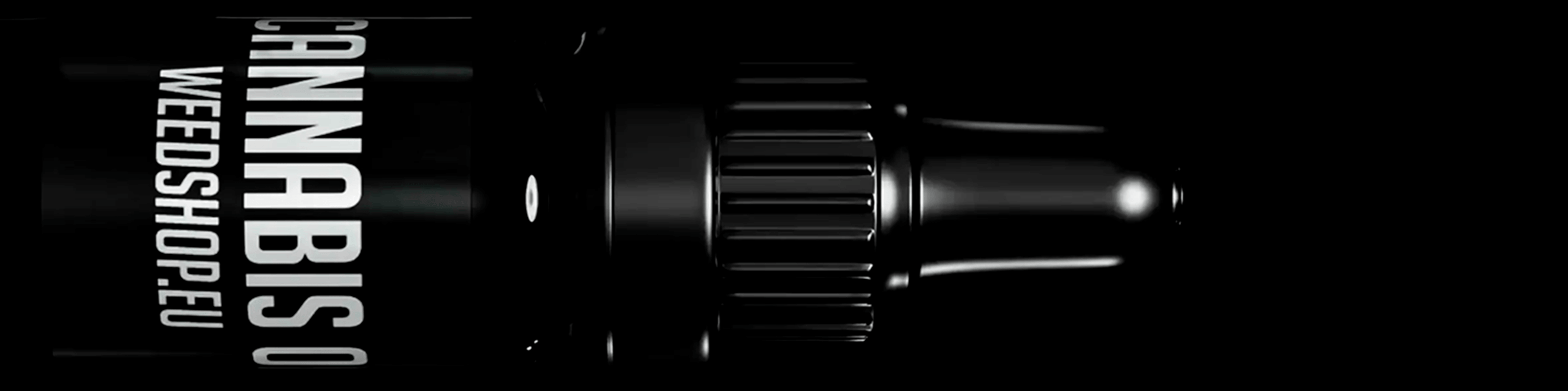 Dark glass dropper bottle labeled cannabis oil against a black background.